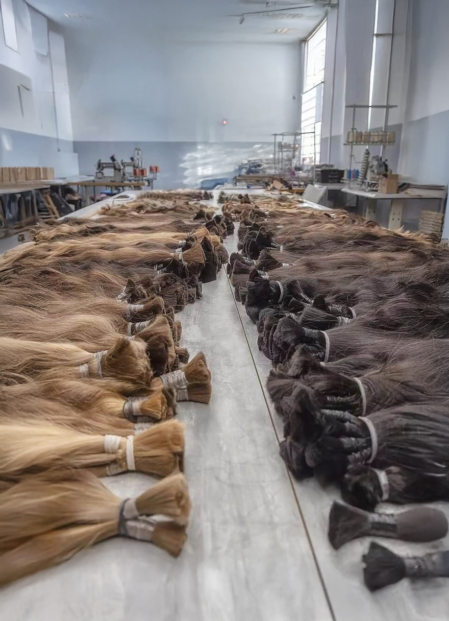 Bulk human hair material inventory in the human hair extensions factory, premium Caucasian hair for professional hair extension manufacturing.