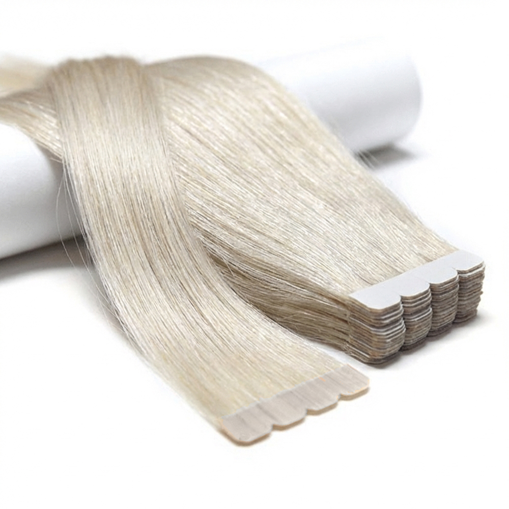 Tape hair Extreme close-up of premium 100% virgin remy cuticle human hair M-tape injected extensions with scalloped edges in icy blonde for B2B wholesale salons.